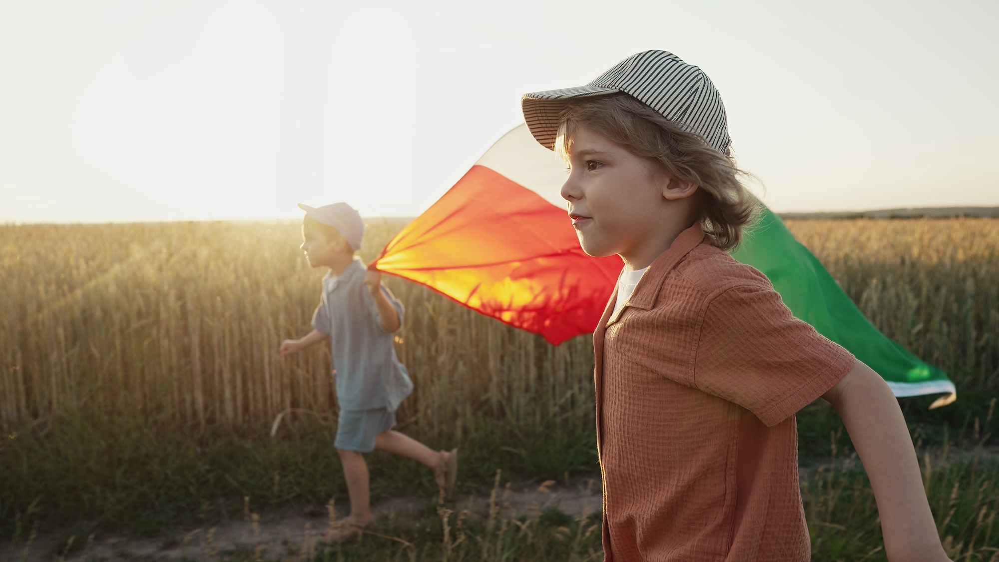 Italian little kids - patriot. football fans children runs with national flag on nature background